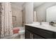 Bathroom with a shower, floral shower curtain, and dark vanity at 4188 Fawn Ivy Ln, Marietta, GA 30064