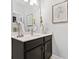 Modern bathroom with a sleek vanity, faucet, artwork, and neutral color scheme at 4188 Fawn Ivy Ln, Marietta, GA 30064