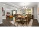Bright dining room features modern chandelier, large table with seating for eight, and hardwood flooring at 4188 Fawn Ivy Ln, Marietta, GA 30064