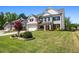 Two-story home boasts a brick and siding facade, a well-manicured lawn, and an attached two-car garage at 4188 Fawn Ivy Ln, Marietta, GA 30064