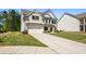 Charming two-story home with a brick front, lush green lawn, and attached two-car garage at 4188 Fawn Ivy Ln, Marietta, GA 30064