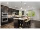 Kitchen with dark cabinets, granite countertop island, stainless steel appliances and counter seating at 4188 Fawn Ivy Ln, Marietta, GA 30064