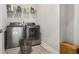 Well-lit laundry room with modern washer, dryer and storage shelves at 4188 Fawn Ivy Ln, Marietta, GA 30064