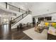 Open-concept living room with staircase and a view of the kitchen featuring hardwood floors at 4188 Fawn Ivy Ln, Marietta, GA 30064