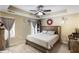 Cozy bedroom featuring a tray ceiling, ceiling fan, a neutral color scheme, and plush carpeting at 102 Hill Crest Cir, Hiram, GA 30141