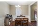 Traditional dining room features dark wood floors, wainscoting, and a classic chandelier at 102 Hill Crest Cir, Hiram, GA 30141