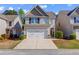 Charming two-story home features a two car garage, neutral siding, and well maintained landscaping at 102 Hill Crest Cir, Hiram, GA 30141
