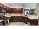 Well-equipped kitchen with stainless steel appliances, granite countertops, and dark wood cabinets at 102 Hill Crest Cir, Hiram, GA 30141