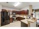 Well-equipped kitchen with stainless steel appliances, granite countertops, and dark wood cabinets at 102 Hill Crest Cir, Hiram, GA 30141