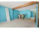 Spacious living room with blue walls, exposed beam and access to other rooms at 1784 Timber Valley Se Way, Smyrna, GA 30080