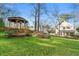 The lawn leads to a beautiful gazebo with a wooden bridge and tranquil water feature surrounded by luscious plants and foliage at 2580 Defoors Ferry Nw Rd, Atlanta, GA 30318