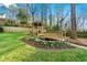 Beautiful backyard features a charming gazebo, a wooden bridge, and a tranquil water feature surrounded by lush greenery at 2580 Defoors Ferry Nw Rd, Atlanta, GA 30318