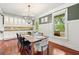 Bright dining room with a modern chandelier, dark wood floors, and wainscoting at 2580 Defoors Ferry Nw Rd, Atlanta, GA 30318