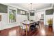 Dining area featuring green accent wall, wainscoting, and decorative chandelier at 2580 Defoors Ferry Nw Rd, Atlanta, GA 30318