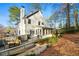 View of the house from the backyard, showing deck, grill, and outdoor dining furniture with lots of sunlight at 2580 Defoors Ferry Nw Rd, Atlanta, GA 30318