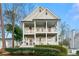 Charming two-story home featuring double porches, a welcoming facade, and manicured landscaping at 2580 Defoors Ferry Nw Rd, Atlanta, GA 30318