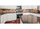 Close-up of the kitchen area with stainless steel appliances and granite countertops at 2580 Defoors Ferry Nw Rd, Atlanta, GA 30318