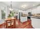 Open concept kitchen with stainless steel appliances, center island, and wooden dining table at 2580 Defoors Ferry Nw Rd, Atlanta, GA 30318