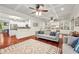 Open-concept living room with coffered ceiling, hardwood floors, and adjacent kitchen at 2580 Defoors Ferry Nw Rd, Atlanta, GA 30318
