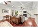 Open-concept living room with coffered ceiling, fireplace, hardwood floors, and comfortable seating at 2580 Defoors Ferry Nw Rd, Atlanta, GA 30318
