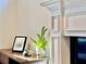 Bright living room featuring a fireplace with traditional white molding and decorative items on the mantle at 2580 Defoors Ferry Nw Rd, Atlanta, GA 30318