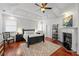 Tranquil main bedroom with a fireplace, tray ceiling, and stylish decor, showcasing a relaxing retreat at 2580 Defoors Ferry Nw Rd, Atlanta, GA 30318
