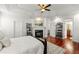 Spacious main bedroom with a fireplace and decorative mantle, gleaming wood floors, and a light color palette at 2580 Defoors Ferry Nw Rd, Atlanta, GA 30318