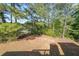 A serene view of the backyard, featuring lush greenery and mature trees for privacy at 3230 Letha Woods Dr, Conyers, GA 30094