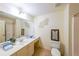 Bright bathroom with a sink, toilet, shower and a large mirror providing amble light at 3230 Letha Woods Dr, Conyers, GA 30094