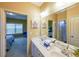 Bathroom with dual sinks and decor, with a view into the bedroom at 3230 Letha Woods Dr, Conyers, GA 30094