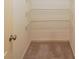 Empty closet with neutral carpet and three layers of wire shelving to provide generous storage space at 3230 Letha Woods Dr, Conyers, GA 30094