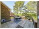 A wooden deck with furniture and natural light surrounded by beautiful lush greenery at 3230 Letha Woods Dr, Conyers, GA 30094