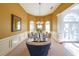 Formal dining room with wainscoting, chandelier, and arched doorway at 3230 Letha Woods Dr, Conyers, GA 30094