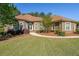 Manicured lawn leads to this brick home with arched windows and lush landscaping at 3230 Letha Woods Dr, Conyers, GA 30094