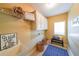 Well-lit laundry room with washer, dryer, cabinets, and a window that provides natural light at 3230 Letha Woods Dr, Conyers, GA 30094