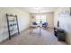 Bright home office with a window, ladder shelf, decor, and two blue cushioned chairs set around a desk at 3230 Letha Woods Dr, Conyers, GA 30094
