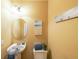 Bright powder room featuring an oval mirror, modern lighting and neutral paint at 3230 Letha Woods Dr, Conyers, GA 30094