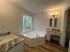 Bathroom with a garden tub, vanity with granite countertops and wood look flooring at 3861 Spring Meadow Dr, Acworth, GA 30101