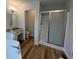 Bright bathroom features a marble countertop vanity, soaking tub, and sliding glass door shower at 3861 Spring Meadow Dr, Acworth, GA 30101