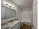Bathroom with updated vanity and countertops, tiled shower and wood look flooring at 3861 Spring Meadow Dr, Acworth, GA 30101