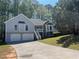 Charming home with two-car garage, front stairs, and stone accents at 3861 Spring Meadow Dr, Acworth, GA 30101