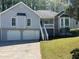 Charming home with two-car garage, front stairs, and stone accents at 3861 Spring Meadow Dr, Acworth, GA 30101
