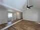 Inviting living room boasts new flooring and a vaulted ceiling with a modern ceiling fan at 3861 Spring Meadow Dr, Acworth, GA 30101