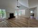 Open living room with fireplace, vaulted ceiling, and hardwood floors at 3861 Spring Meadow Dr, Acworth, GA 30101