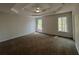 Spacious main bedroom with a tray ceiling, fan, carpet and large windows at 3861 Spring Meadow Dr, Acworth, GA 30101