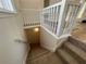 Carpeted stairway with white railing leads to the downstairs area at 3861 Spring Meadow Dr, Acworth, GA 30101