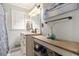 Well-lit bathroom featuring a vanity with storage and a mirror, plus a shower with a decorative curtain at 4715 Howard Dr, Powder Springs, GA 30127