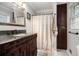 Elegant bathroom featuring a vanity with granite countertop and a decorative shower curtain at 4715 Howard Dr, Powder Springs, GA 30127