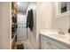 Cozy bathroom featuring a stacked washer and dryer and a vanity with a sink and storage at 4715 Howard Dr, Powder Springs, GA 30127