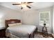 Comfortable bedroom with a wooden bed frame, ceiling fan, and natural light from the window at 4715 Howard Dr, Powder Springs, GA 30127